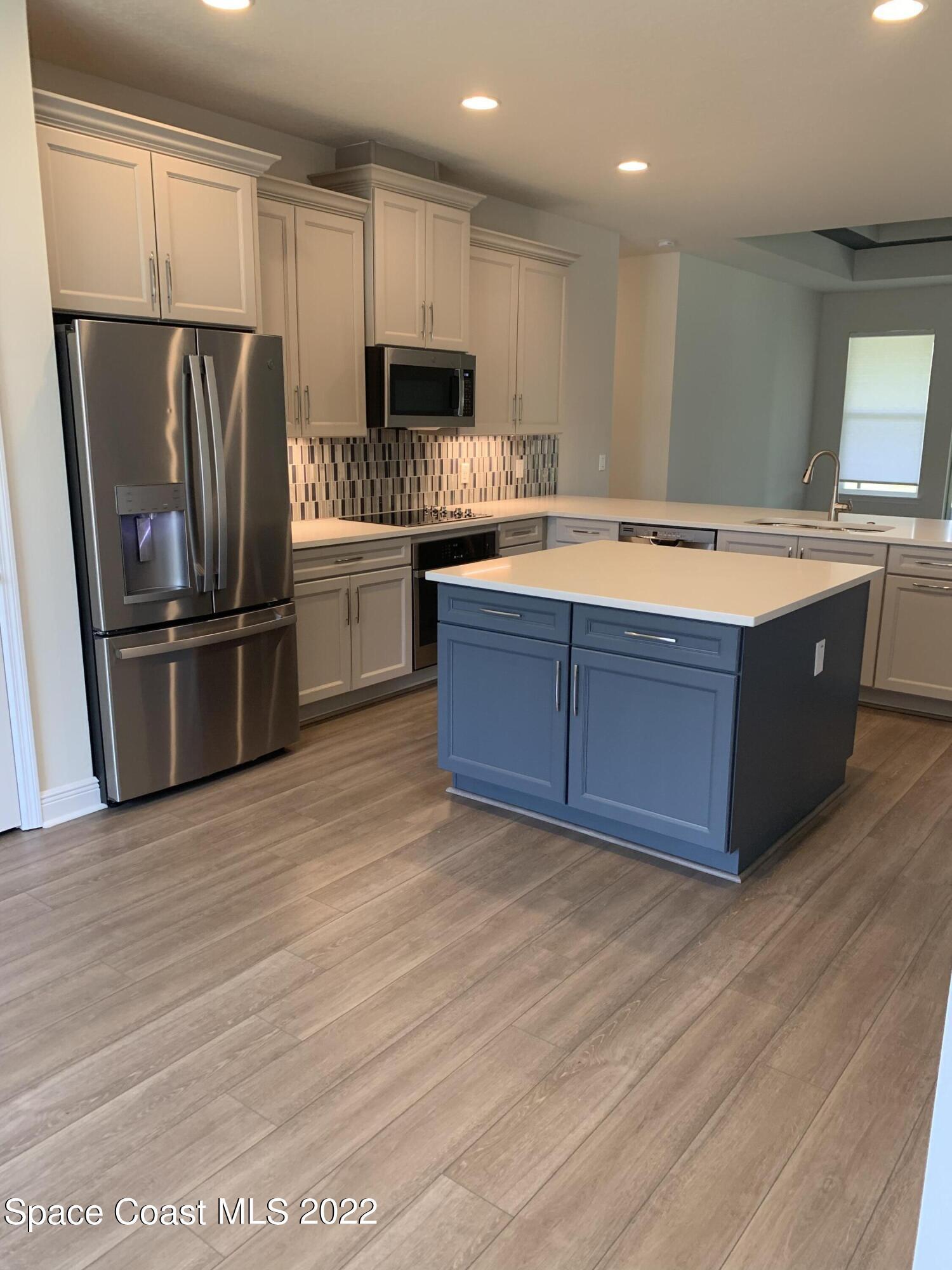 1893 Killian Drive Palm Bay, FL 32905 - Photo 3 of 25 a kitchen with stainless steel appliances granite countertop a refrigerator a stove and a sink
