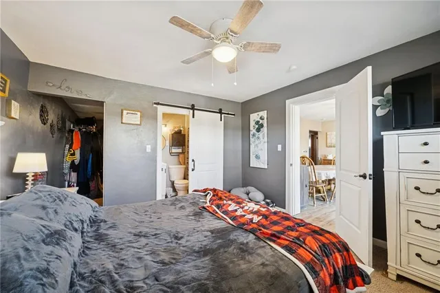 a bedroom with a bed and a flat tv screen