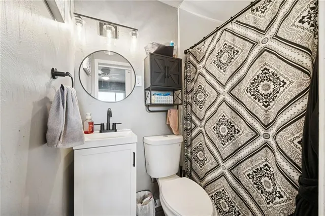 a bathroom with a toilet a sink and a mirror