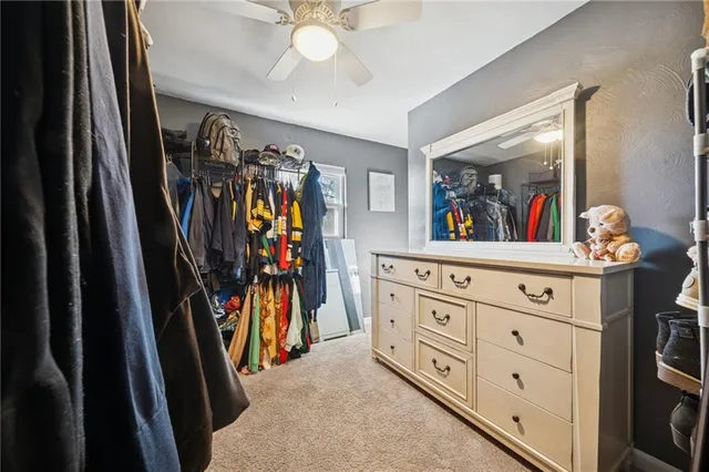 a view of a hallway with a cabinet and a chandelier