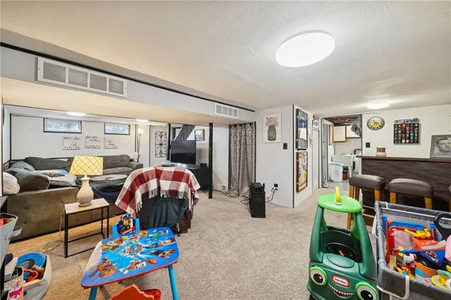 a living room filled with furniture and a dining table