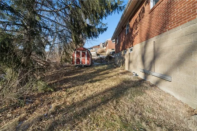 a view of a yard with large trees