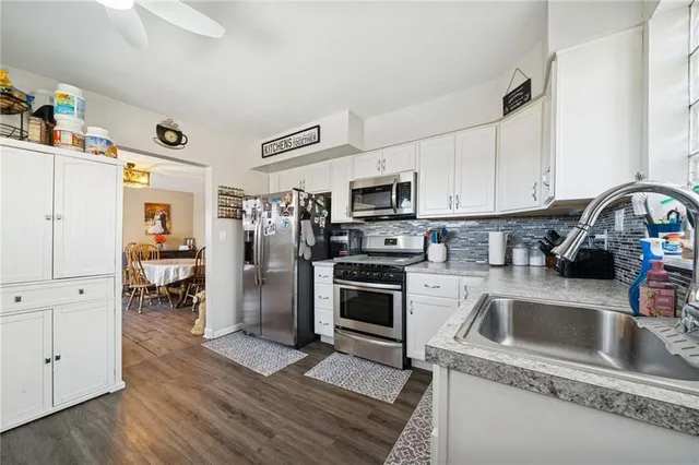 a kitchen with a sink cabinets and stainless steel appliances