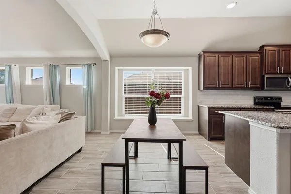 a kitchen with a refrigerator a sink and wooden floor