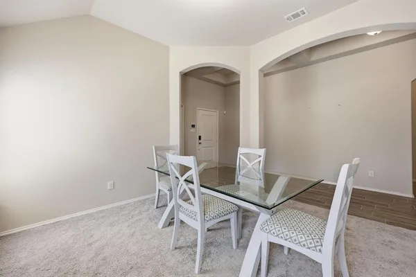 a large kitchen with sink a refrigerator and wooden cabinets