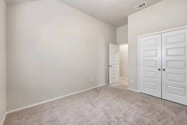 a view of a hallway with wooden floor and a livingroom