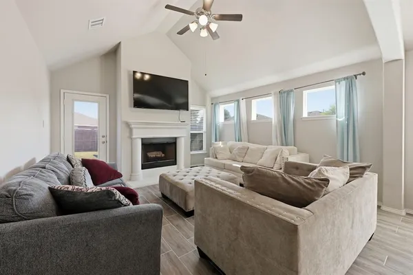 a living room with furniture fireplace and flat screen tv