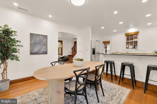 a dining room with furniture and wooden floor