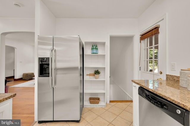 a kitchen with a refrigerator and a sink