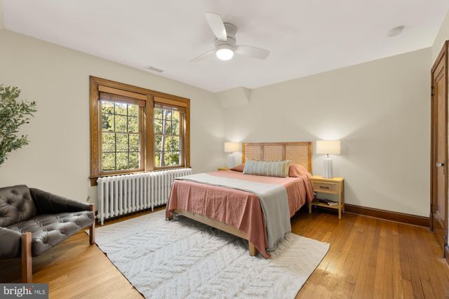 a spacious bedroom with a bed and a couch