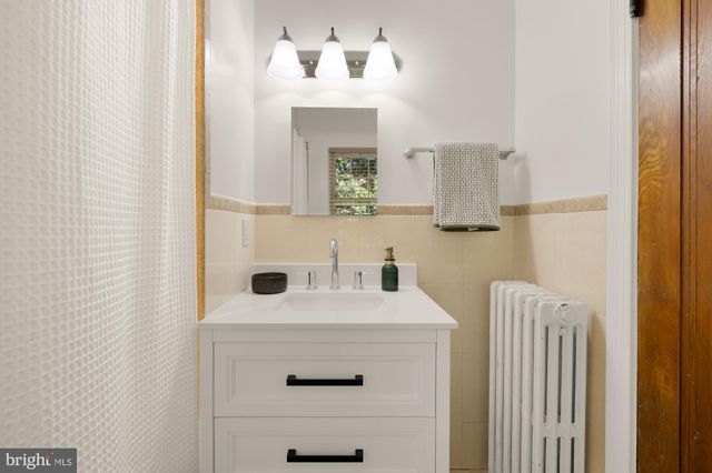 a bathroom with a sink a mirror and vanity