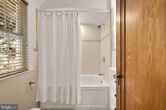 a bathroom with a shower and a mirror