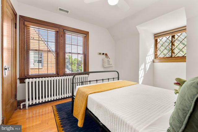 a bedroom with a bed and a window with outer view
