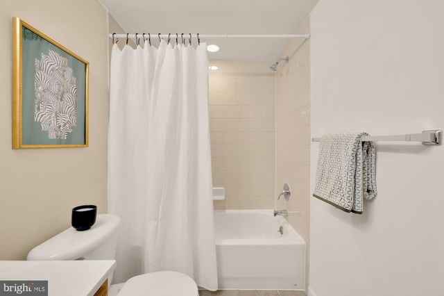 a bathroom with a shower curtain and a sink