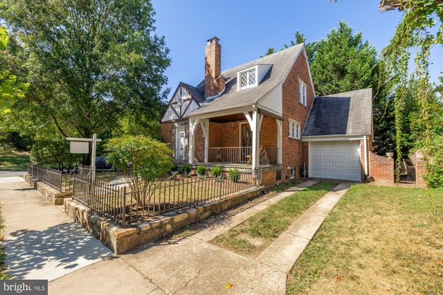 a front view of house with a garden