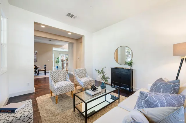 a dining room with furniture window and wooden floor
