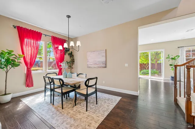 a kitchen with stainless steel appliances kitchen island granite countertop a sink refrigerator and cabinets