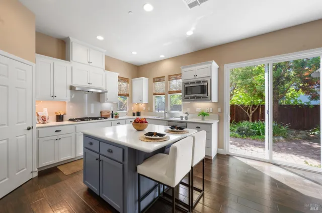 a living room with furniture a fireplace and a large window