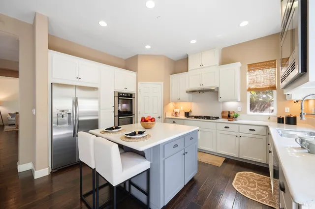 a living room with furniture and large windows