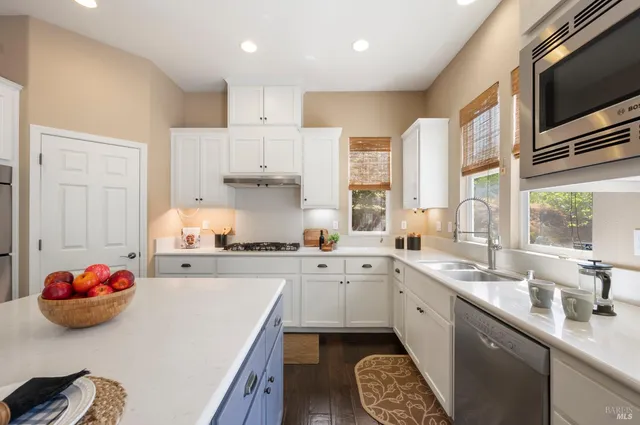 a living room with furniture flowerpot and wooden floor