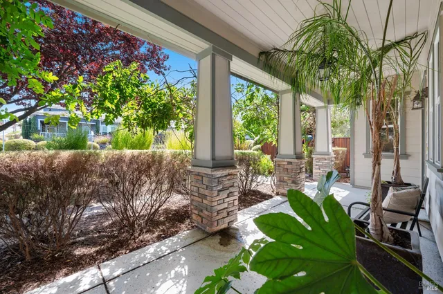 a view of a patio with table and chairs and potted plants