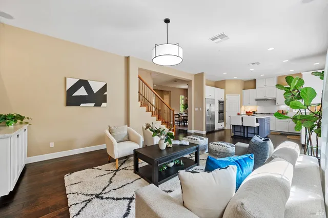 a bedroom with a bed and paintings on the wall