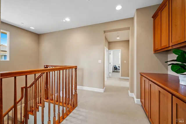 a bathroom with a granite countertop sink and a window