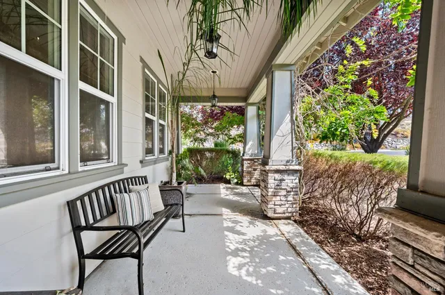 a front view of a house with a tree