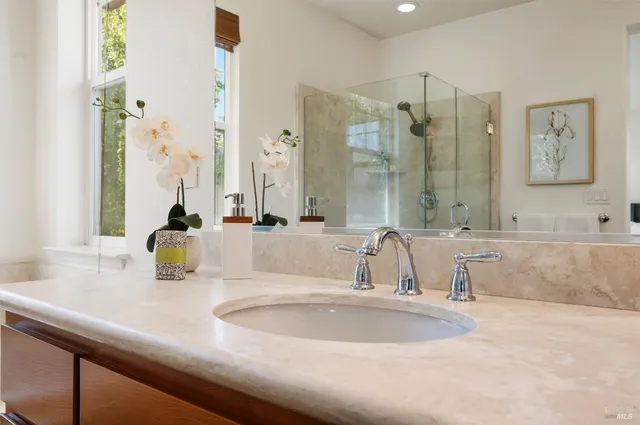 a bathroom with a double vanity sink toilet and a mirror