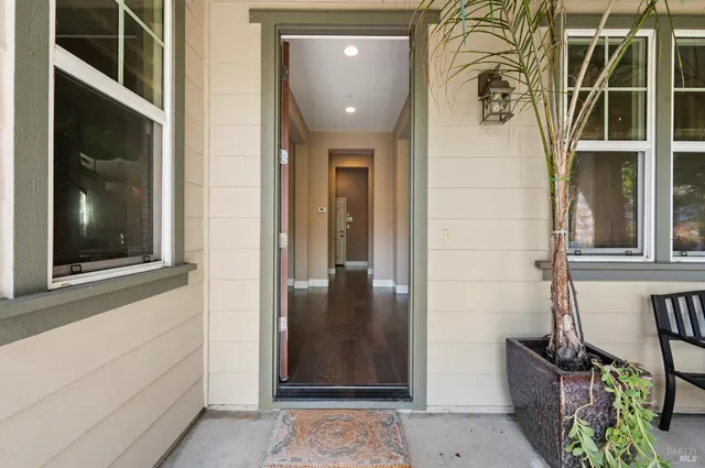 a view of a room with wooden floor and glass windows