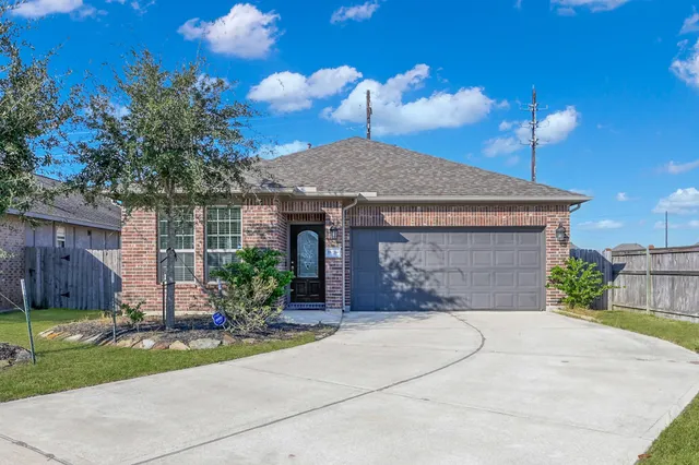 a front view of a house with yard and a garage