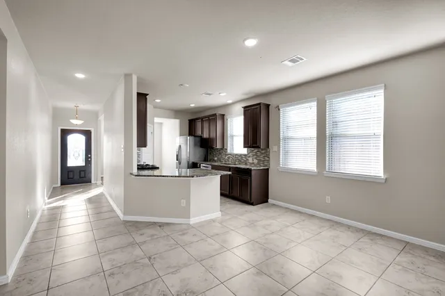 a large white kitchen with a stove a sink dishwasher and a refrigerator