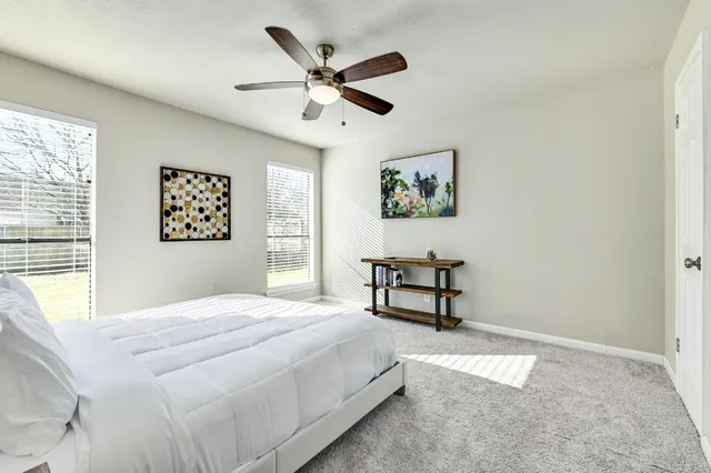 a bedroom with a bed and window