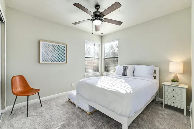 a bedroom with a bed and a chair