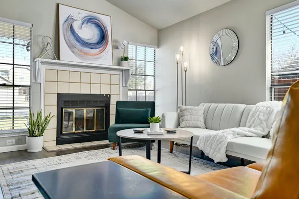 a living room with furniture a rug and a fireplace