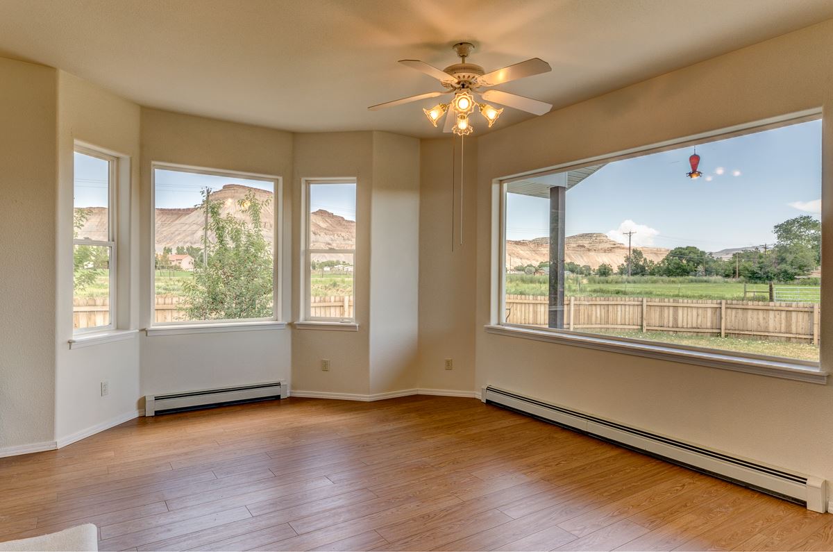 3405 F Road Clifton, CO 81520 - Photo 3 of 42 a view of an empty room with a window and wooden floor
