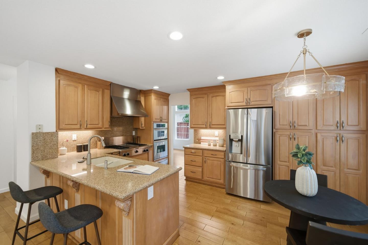 375 Montevideo Circle Fremont, CA 94539 - Photo 12 of 45 a kitchen with a refrigerator a stove a sink and chairs