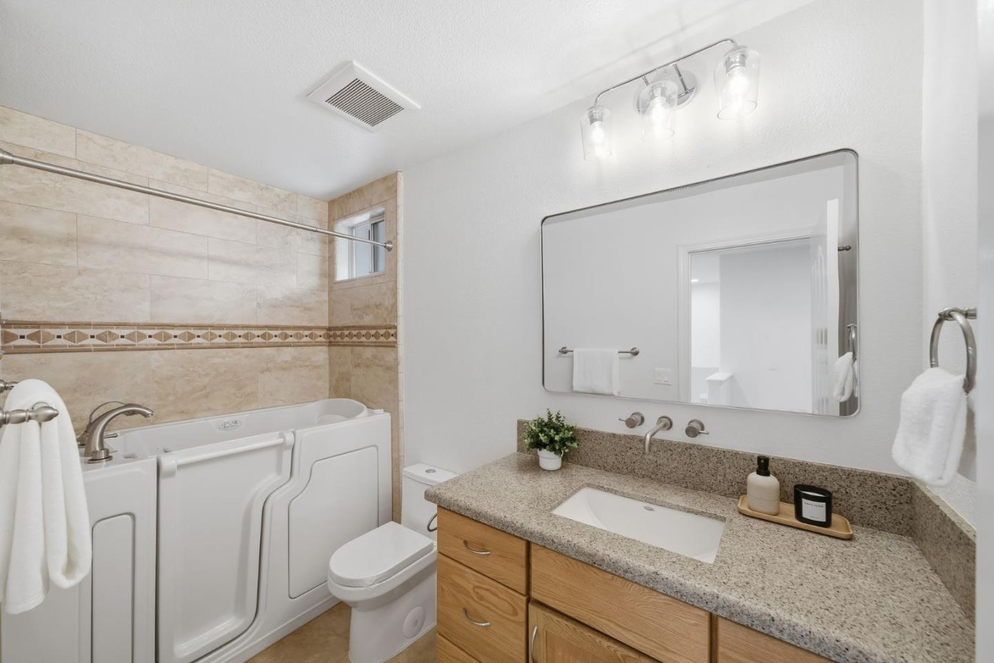 375 Montevideo Circle Fremont, CA 94539 - Photo 22 of 45 a bathroom with a granite countertop toilet sink and mirror