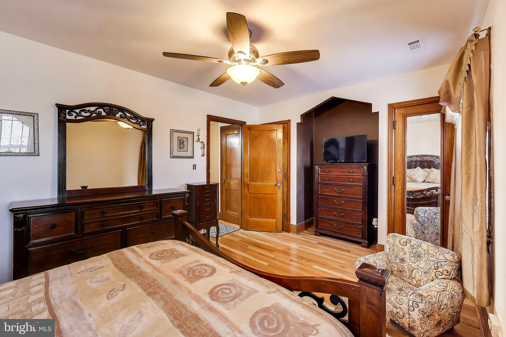 1655 C Street Northeast Washington, DC 20002 - Photo 11 of 18 a bedroom with a bed and a chandelier