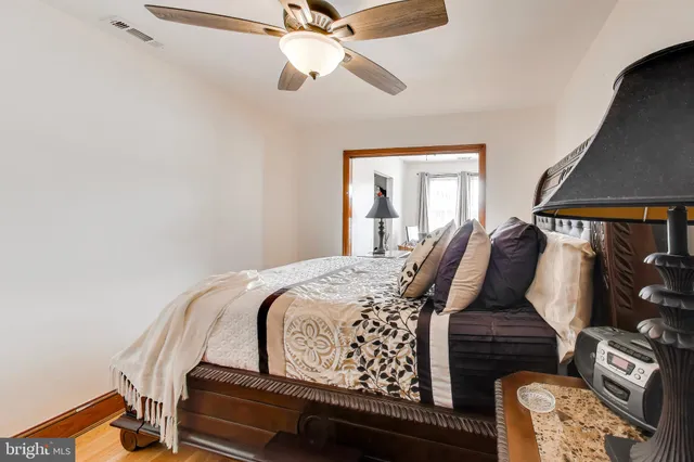 a bedroom with bed and wooden floor
