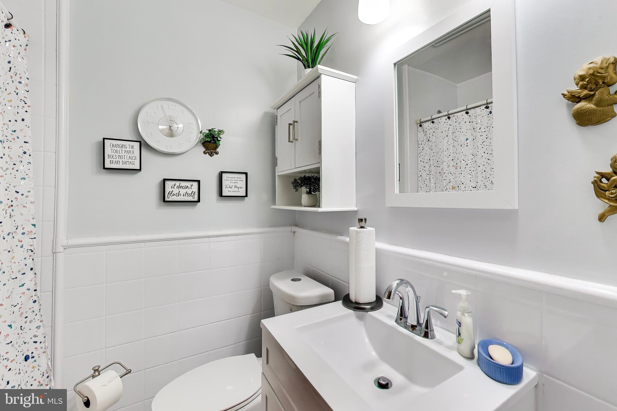 1655 C Street Northeast Washington, DC 20002 - Photo 17 of 18 a bathroom with a toilet sink and mirror