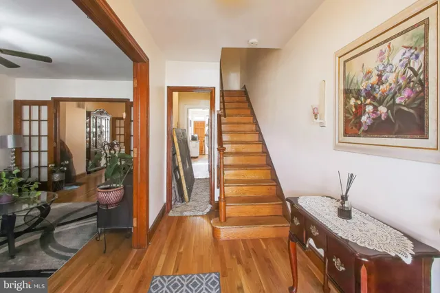 a view of a hallway with wooden floor and stairs