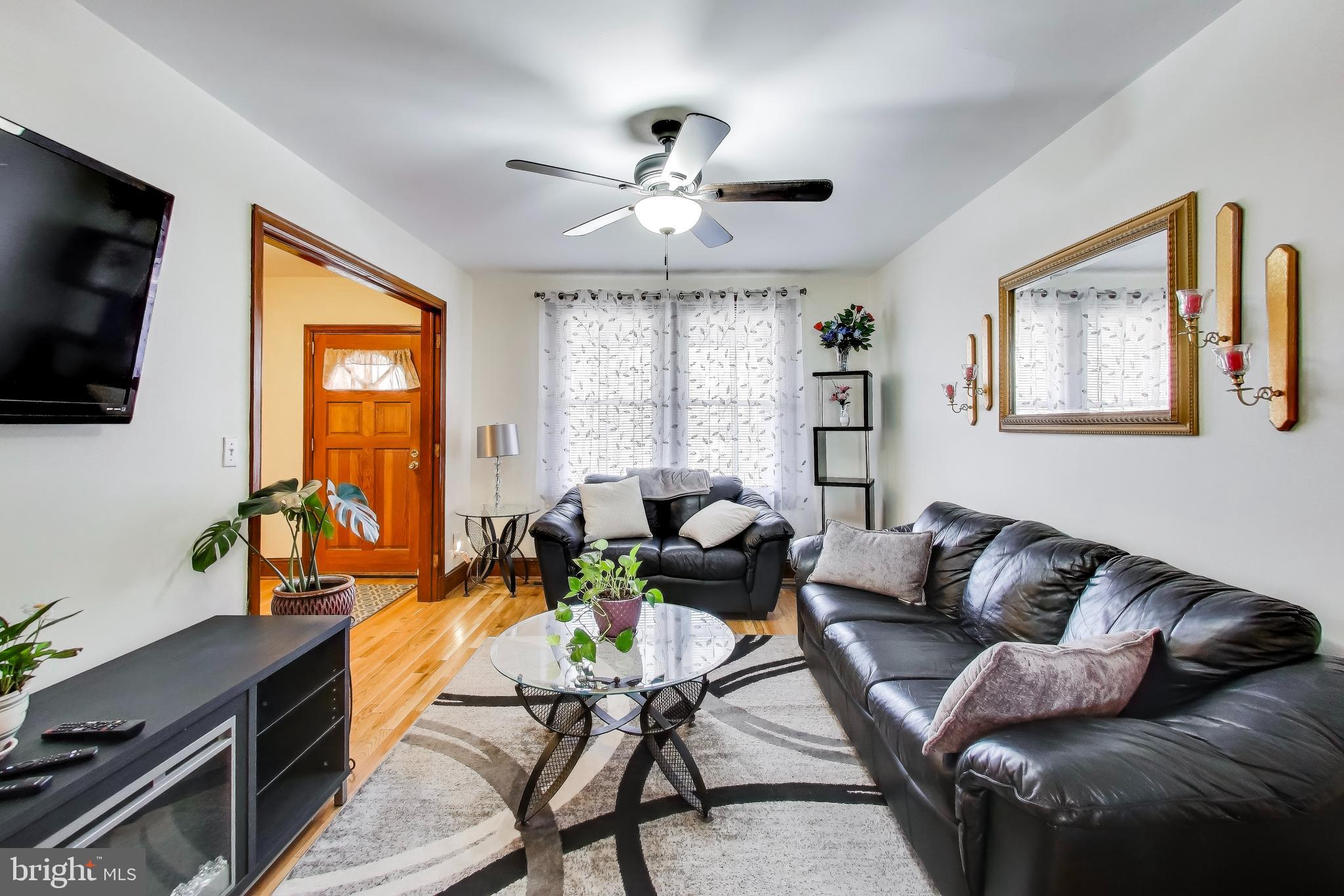 1655 C Street Northeast Washington, DC 20002 - Photo 4 of 18 a living room with furniture ceiling fan and a flat screen tv
