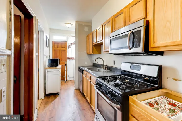 a kitchen with stainless steel appliances granite countertop a stove and a refrigerator a sink