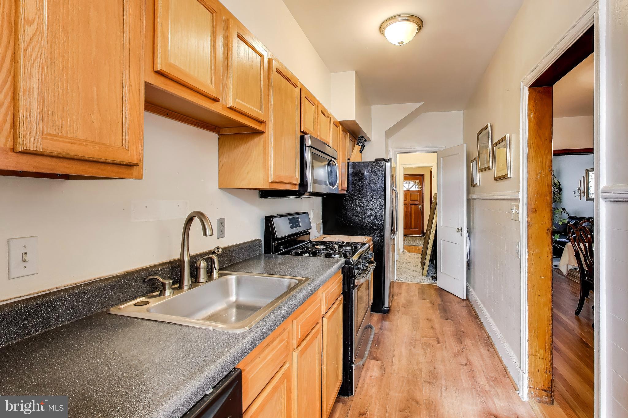 1655 C Street Northeast Washington, DC 20002 - Photo 8 of 18 a kitchen with stainless steel appliances granite countertop a sink a stove and a refrigerator