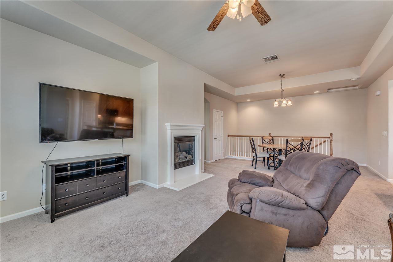 1725 Wind Ranch Road, Unit C Reno, NV 89521 - Photo 12 of 29 a living room with furniture and a flat screen tv
