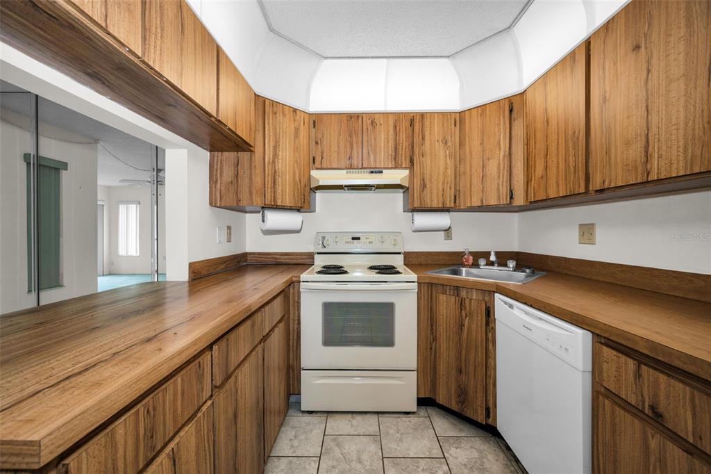 2687 Pine Ridge Way South, Unit B2 Palm Harbor, FL 34684 - Photo 10 of 68 a kitchen with a sink stove and cabinets