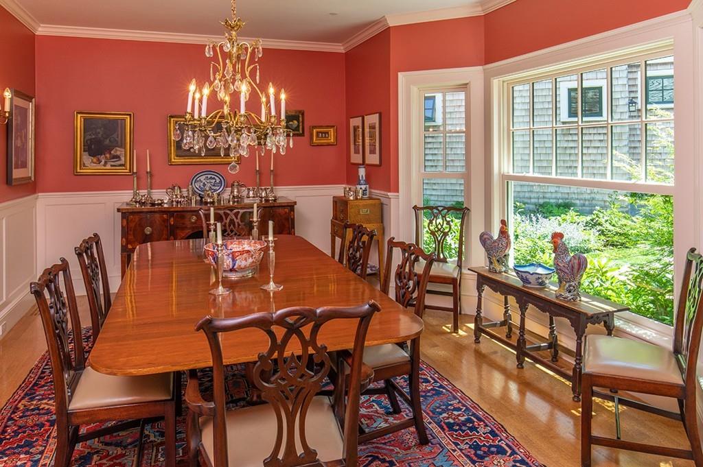 10 Smiths Point Road Manchester, MA 01944 - Photo 14 of 25 a view of a dining room with furniture a chandelier and wooden floor