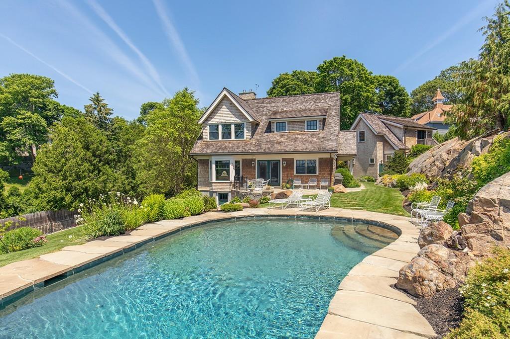 10 Smiths Point Road Manchester, MA 01944 - Photo 15 of 25 a front view of a house with swimming pool having outdoor seating