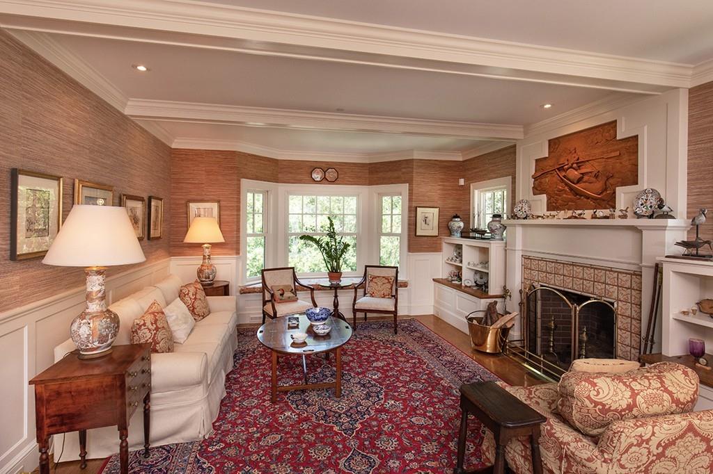 10 Smiths Point Road Manchester, MA 01944 - Photo 16 of 25 a living room with furniture a fireplace and a table